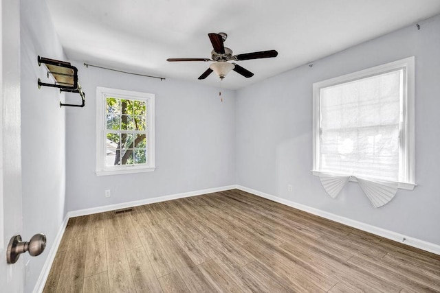 spare room featuring ceiling fan and light wood-type flooring