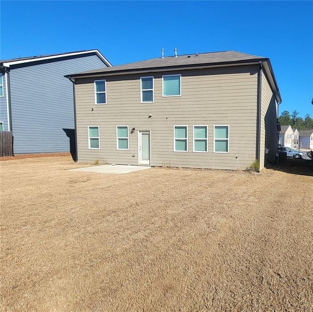 back of house featuring a yard and a patio