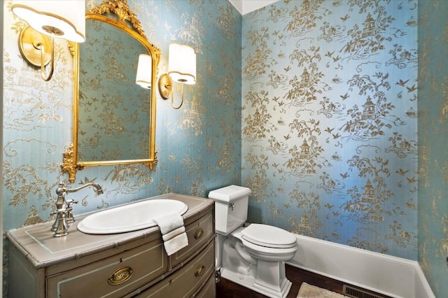 6440 Westchester Pl, Cumming, GA 30040 - bathroom with vanity, wallpapered walls, toilet, and wood finished floors
