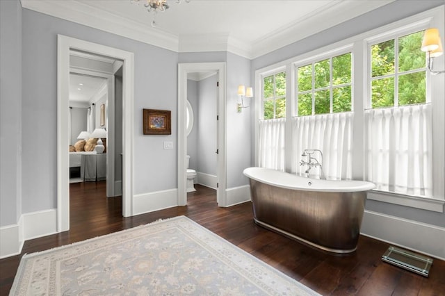 6440 Westchester Pl, Cumming, GA 30040 - ensuite bathroom with a freestanding bath, wood-type flooring, ornamental molding, toilet, and baseboards