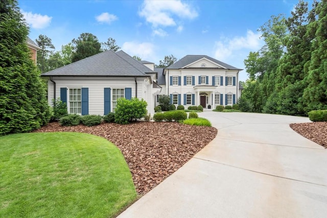 6440 Westchester Pl, Cumming, GA 30040 - neoclassical / greek revival house featuring a front lawn and concrete driveway