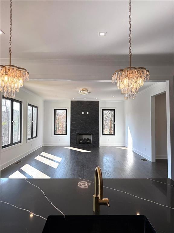 interior space with dark hardwood / wood-style flooring, plenty of natural light, and a chandelier