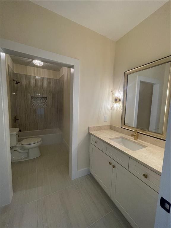 full bathroom featuring vanity, tiled shower / bath combo, and toilet