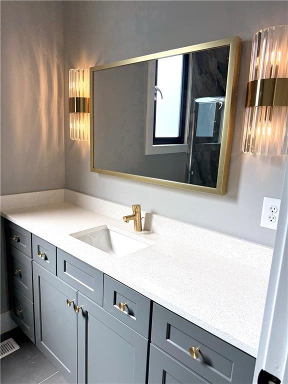 bathroom with vanity and a shower