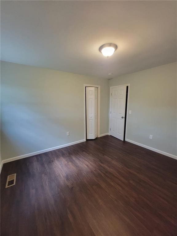 empty room featuring dark hardwood / wood-style floors