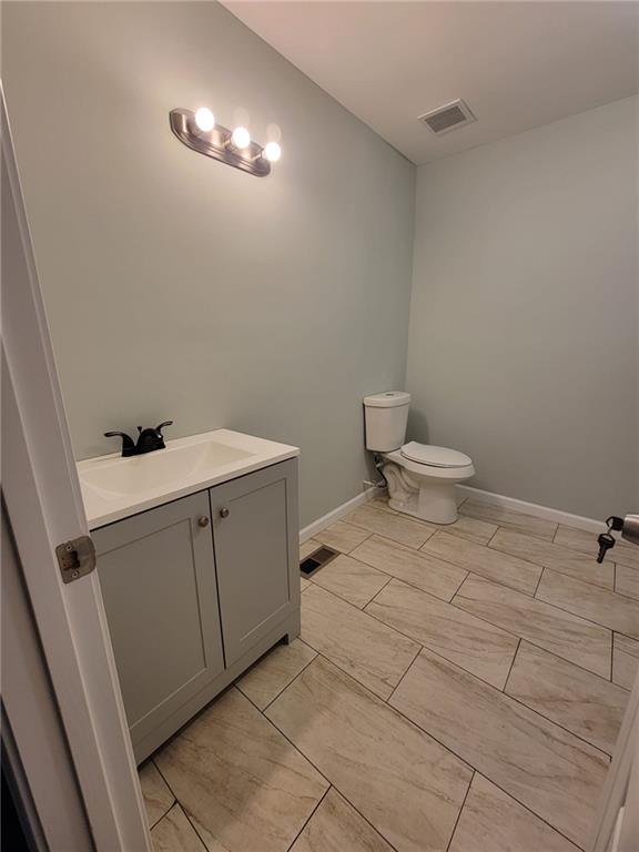 bathroom featuring vanity and toilet