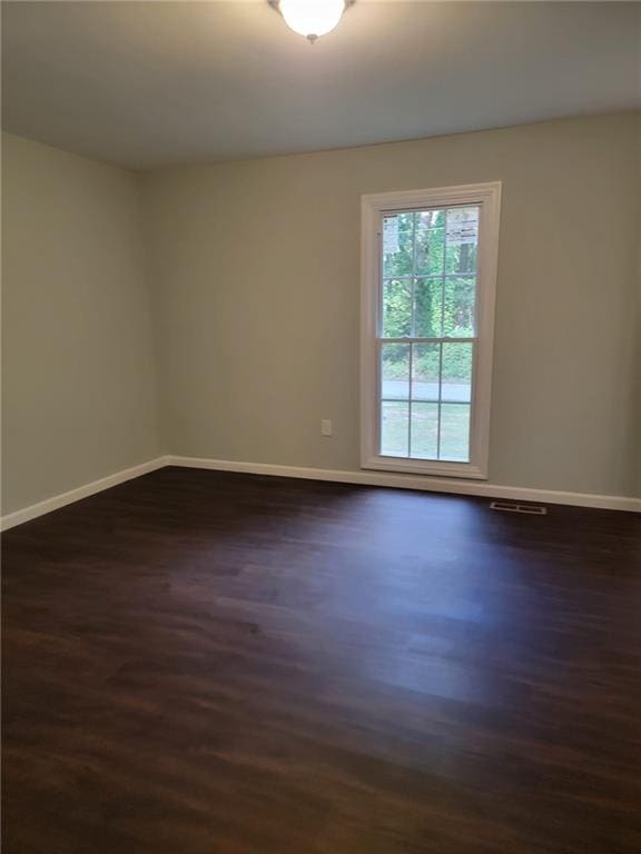 empty room featuring dark wood-type flooring