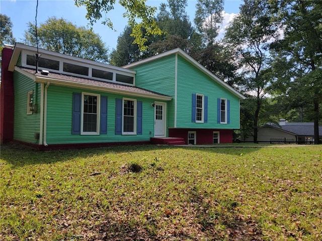 rear view of property with a yard