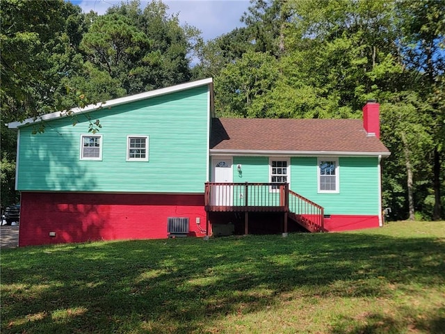 rear view of house featuring a wooden deck, cooling unit, and a lawn