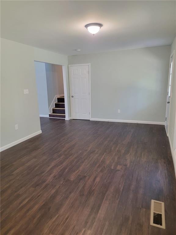 unfurnished room featuring dark hardwood / wood-style floors