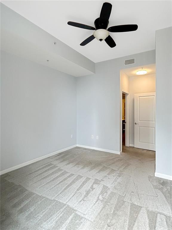 3040 Peachtree Rd NW Unit 1501, Atlanta, GA 30305 - carpeted empty room with ceiling fan and baseboards