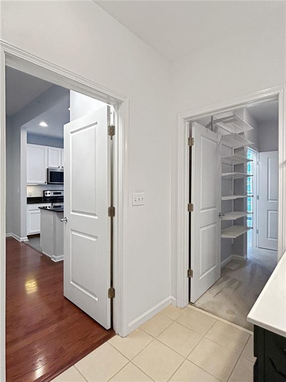 3040 Peachtree Rd NW Unit 1501, Atlanta, GA 30305 - hallway with baseboards and light wood-style flooring