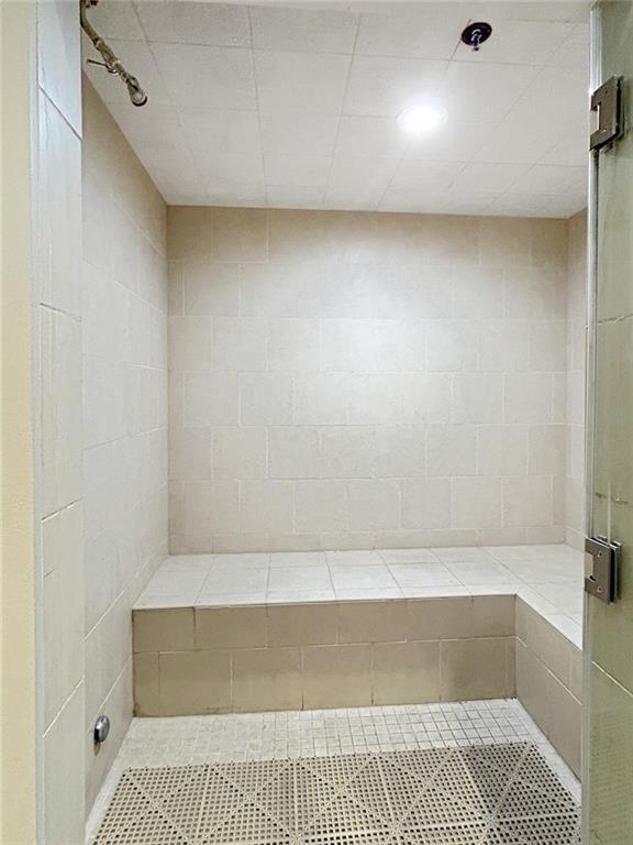 3040 Peachtree Rd NW Unit 1501, Atlanta, GA 30305 - full bathroom featuring a shower stall and tile patterned flooring