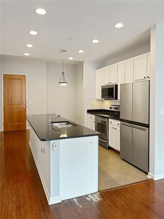 3040 Peachtree Rd NW Unit 1501, Atlanta, GA 30305 - kitchen with stainless steel appliances, a sink, dark countertops, recessed lighting, and dark wood-style floors