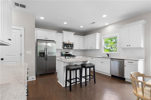 35 Bridgestone Way SE, Cartersville, GA 30120 - kitchen with stainless steel appliances, white cabinets, tasteful backsplash, dark wood-style floors, and recessed lighting