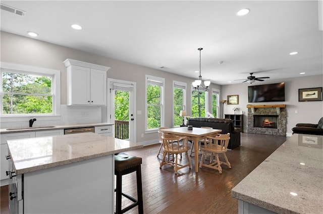 35 Bridgestone Way SE, Cartersville, GA 30120 - kitchen featuring a stone fireplace, a sink, white cabinetry, a ceiling fan, and recessed lighting