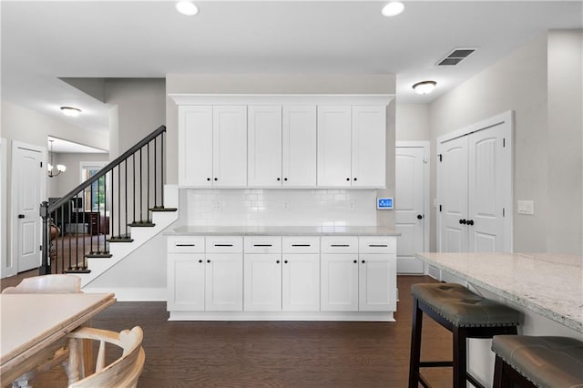 35 Bridgestone Way SE, Cartersville, GA 30120 - kitchen with white cabinets, recessed lighting, backsplash, dark wood-style floors, and light stone counters