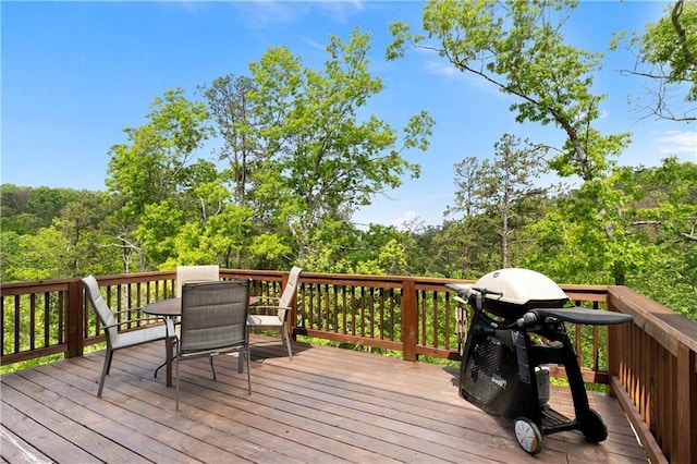 35 Bridgestone Way SE, Cartersville, GA 30120 - wooden terrace featuring outdoor dining space, a grill, and a view of trees