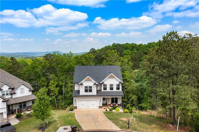 35 Bridgestone Way SE, Cartersville, GA 30120 - view of front facade with a wooded view, driveway, covered porch, an attached garage, and a front yard