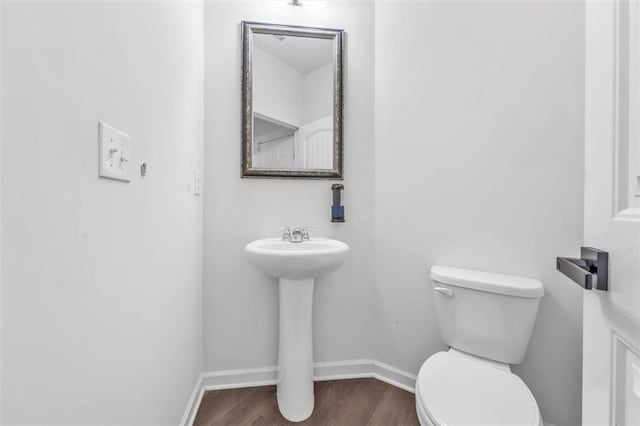 5668 Union Pointe Dr, Union City, GA 30291 - half bath featuring toilet, wood finished floors, baseboards, and a sink