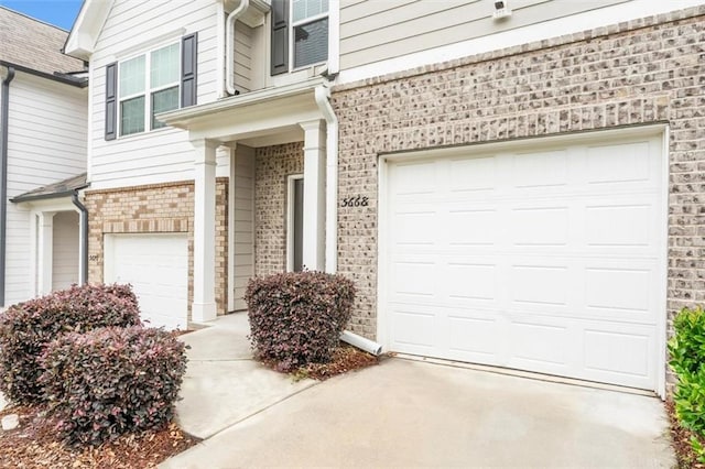 5668 Union Pointe Dr, Union City, GA 30291 - doorway to property featuring brick siding, concrete driveway, and a garage