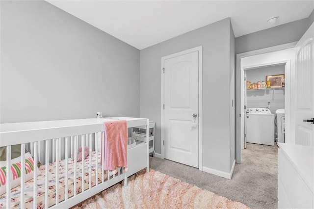 5668 Union Pointe Dr, Union City, GA 30291 - bedroom with washer and clothes dryer, light colored carpet, baseboards, and a crib