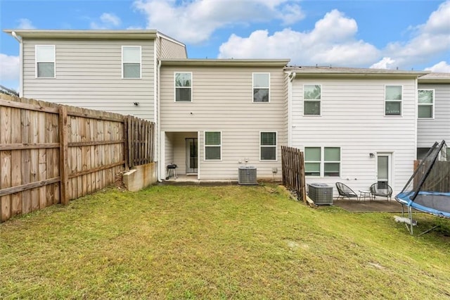 5668 Union Pointe Dr, Union City, GA 30291 - back of property with a trampoline, a patio, and central AC