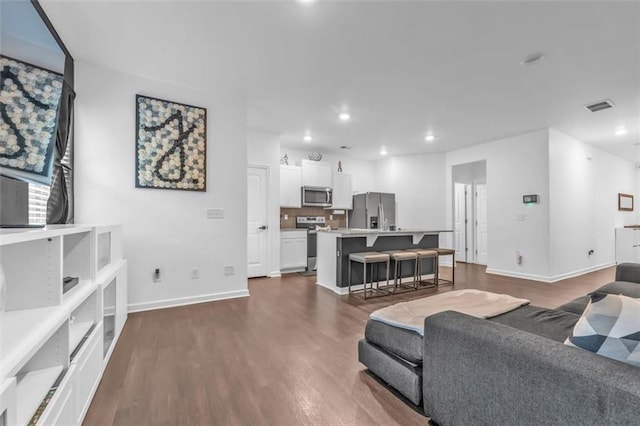 5668 Union Pointe Dr, Union City, GA 30291 - living room with dark wood-style flooring, baseboards, and recessed lighting