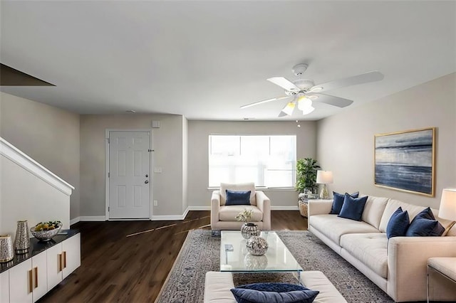 living room with dark hardwood / wood-style flooring and ceiling fan