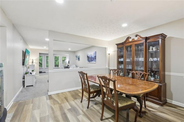 dining room featuring recessed lighting, baseboards, and light wood finished floors