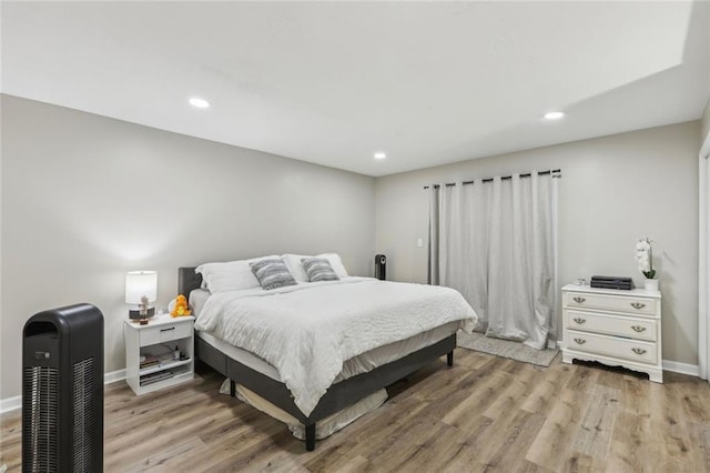 bedroom with light wood-style floors, recessed lighting, and baseboards