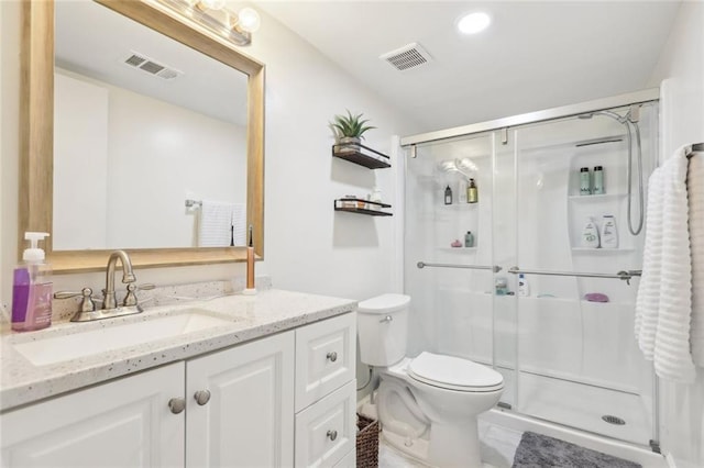 full bathroom featuring visible vents, toilet, and a shower stall