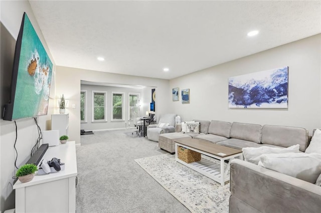 living room with carpet floors, baseboards, and recessed lighting