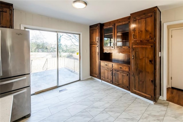 interior space featuring stainless steel fridge