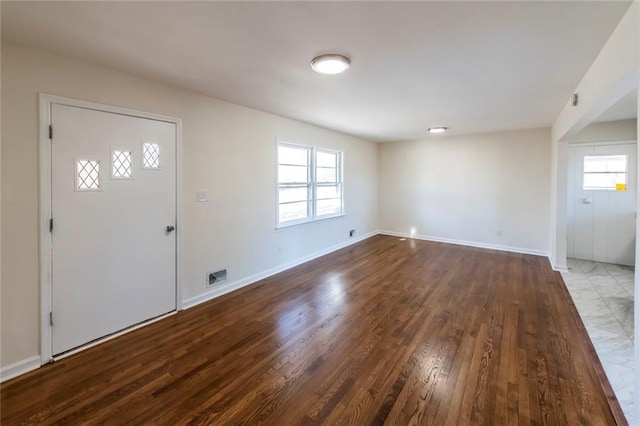 entryway with a wealth of natural light and hardwood / wood-style floors