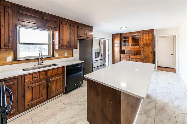 kitchen featuring dishwasher, decorative backsplash, sink, a kitchen island, and stainless steel fridge