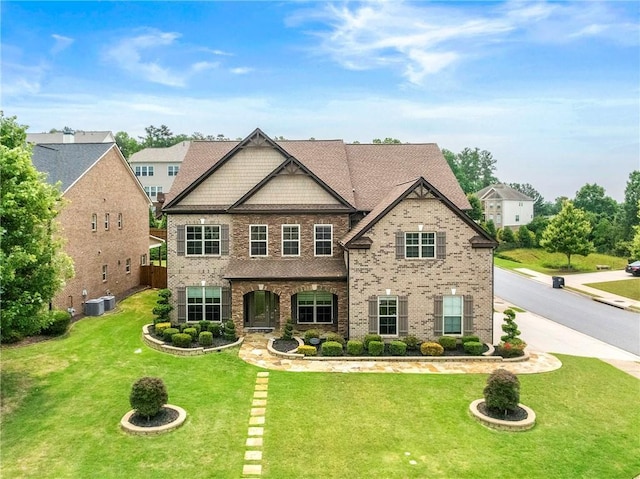 4015 Roberts Crest Ln, Suwanee, GA 30024 - view of front of property with a front yard, brick siding, and central air condition unit