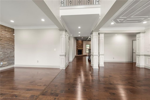 4015 Roberts Crest Ln, Suwanee, GA 30024 - unfurnished living room with a large fireplace, ornate columns, dark wood finished floors, ornamental molding, and recessed lighting