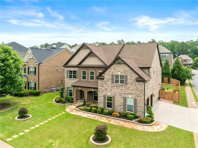 4015 Roberts Crest Ln, Suwanee, GA 30024 - view of front of home featuring concrete driveway, an attached garage, a front lawn, and brick siding
