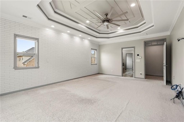 4015 Roberts Crest Ln, Suwanee, GA 30024 - carpeted empty room featuring a raised ceiling, brick wall, a ceiling fan, crown molding, and baseboards