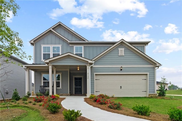 craftsman inspired home with a garage and a front lawn