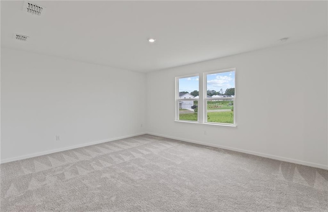 unfurnished room featuring baseboards, recessed lighting, visible vents, and light colored carpet