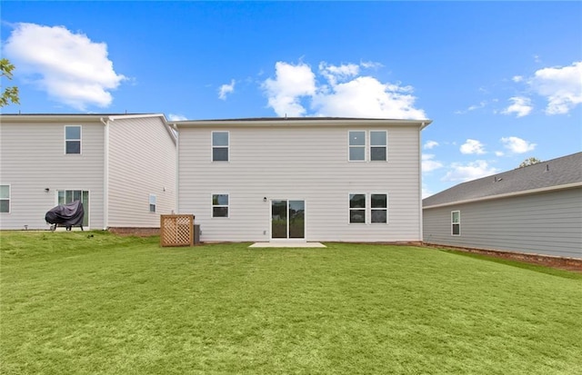 rear view of house featuring a yard