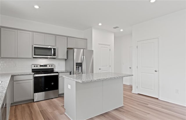 kitchen with light wood-style floors, gray cabinets, and stainless steel appliances