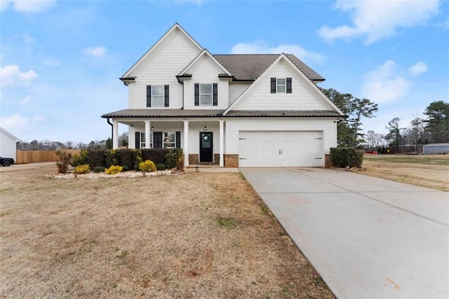 view of front facade featuring a porch, a garage, and a front yard