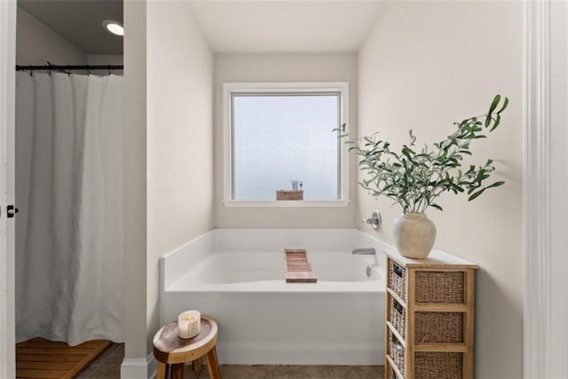 bathroom featuring tile patterned floors and a tub