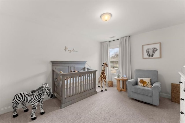 bedroom featuring light colored carpet and a crib