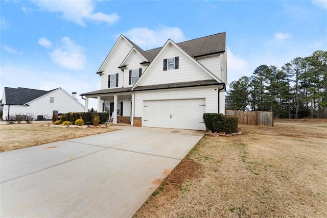 view of front of house featuring a garage, a porch, and a front yard