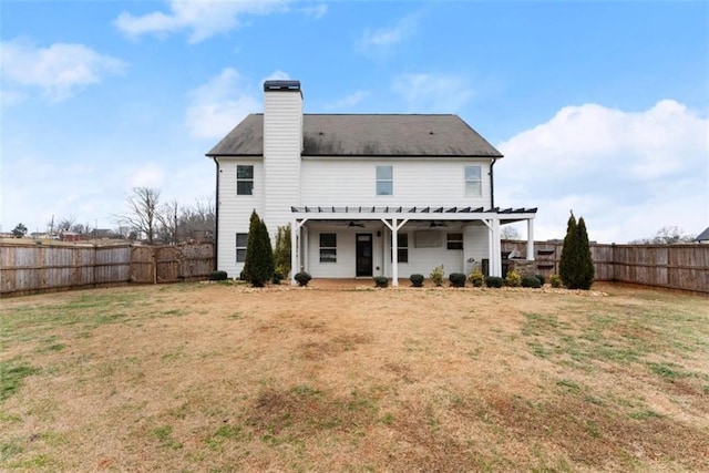 back of property featuring a pergola and a lawn