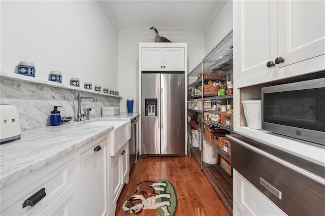 3842 Ernest W Barrett Pkwy SW, Marietta, GA 30064 - kitchen featuring stainless steel appliances, white cabinetry, dark wood-style flooring, decorative backsplash, and a sink